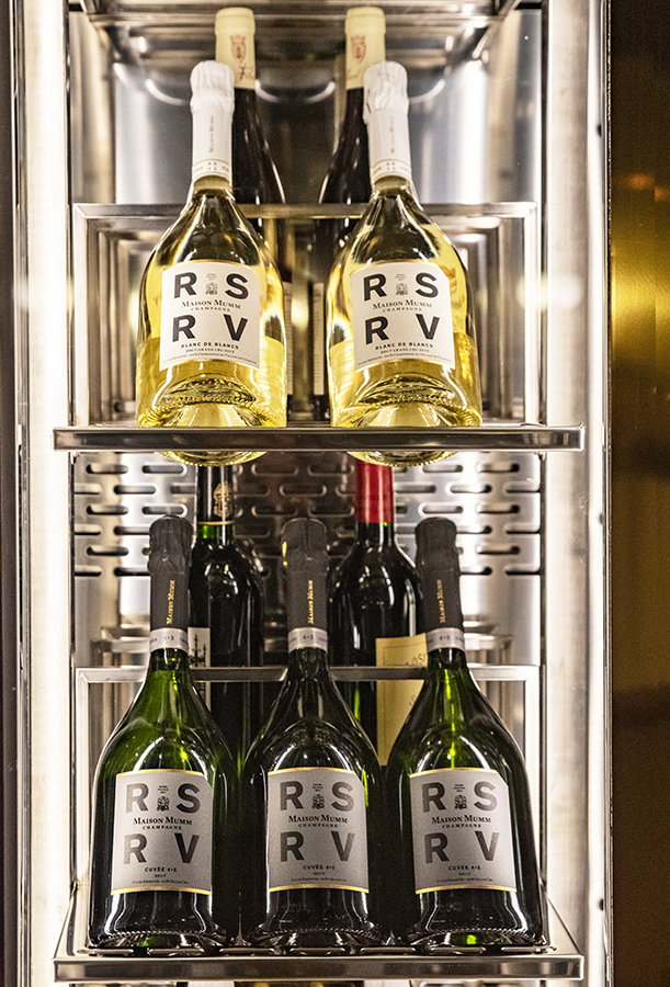 Different Champagne bottles in a wine storage cabinet